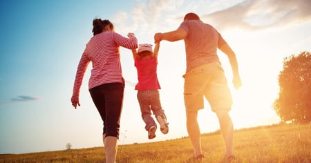 family walking into sunset
